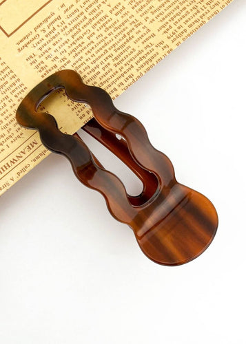 Brown hair clip on a newspaper background