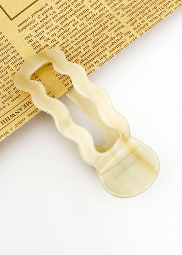 Decorative wooden letter 'A' on a textured surface with text.