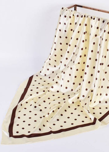 Beige scarf with brown polka dots on a white background