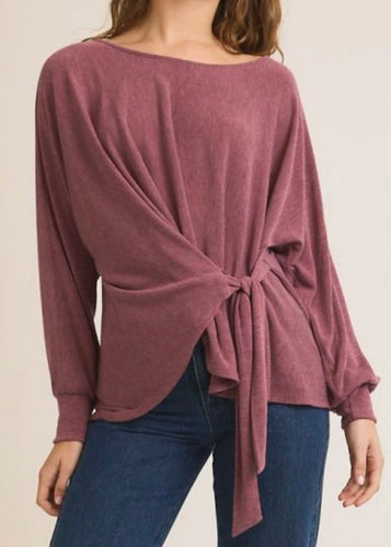 Mauve long-sleeve top with knot detail worn by a person on a plain background