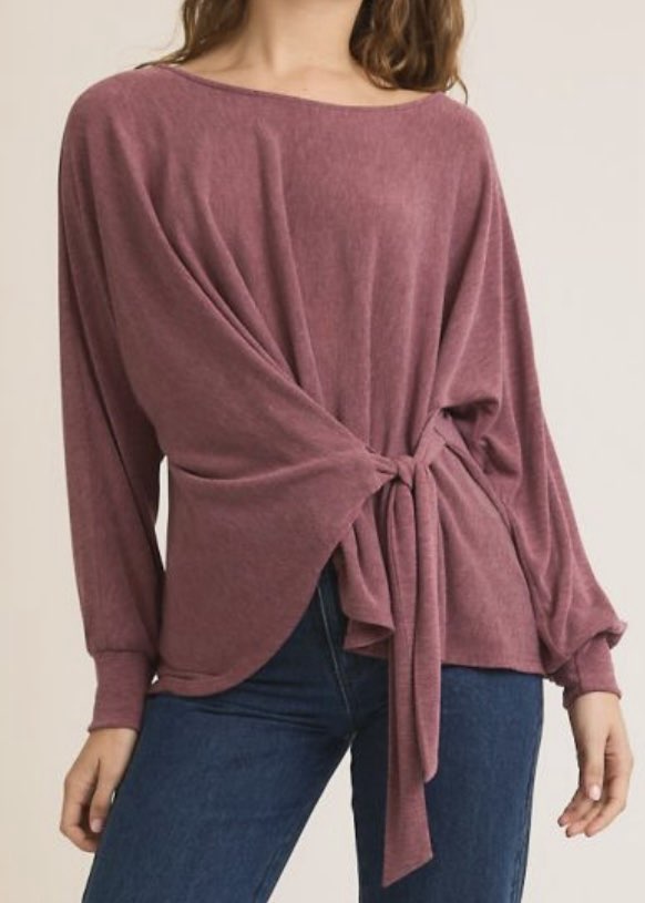 Mauve long-sleeve top with knot detail worn by a person on a plain background