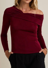 Load image into Gallery viewer, Maroon off-shoulder top worn by a person on a beige background
