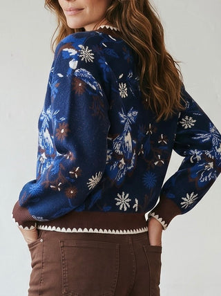 SKIES ARE BLUE Midnight Bloom Intarsia cardigan displayed in a cozy, detailed knit pattern with a front button closure.