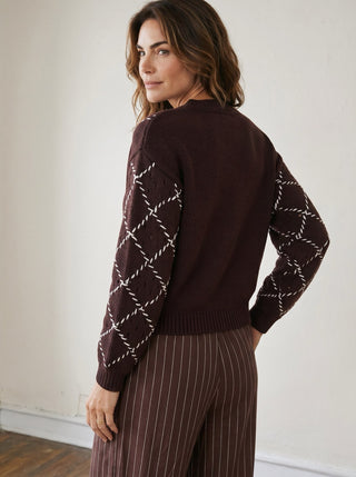 Skies Are Blue whipstitch button cardigan in soft knit, featuring a classic design with visible buttons and detailed stitching.