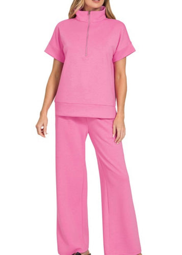 Person wearing a pink outfit on a white background