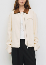 Load image into Gallery viewer, Person wearing a cream jacket and black pants against a white background
