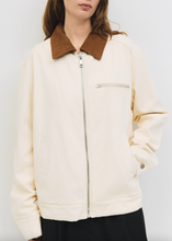 Load image into Gallery viewer, White jacket with brown collar worn by a person against a white background
