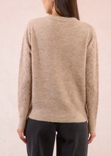 Load image into Gallery viewer, Beige sweater worn by a person on a plain background
