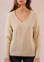 Load image into Gallery viewer, Beige sweater worn by a person on a plain background
