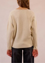 Load image into Gallery viewer, Beige sweater worn by a person on a plain background
