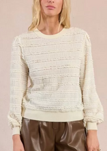 Load image into Gallery viewer, Woman wearing a textured white sweater and brown shorts against a light pink background
