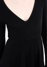 Load image into Gallery viewer, Black dress with a deep neckline and long sleeves on a white background
