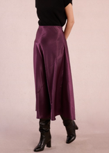 Load image into Gallery viewer, Person wearing a long purple skirt and black boots on a plain background

