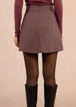 Load image into Gallery viewer, Person wearing a patterned skirt with a plain background
