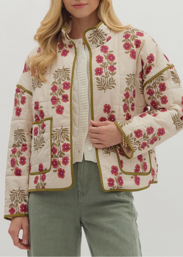 Woman wearing a floral jacket on a plain background