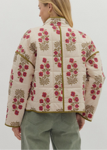 Load image into Gallery viewer, Woman wearing a floral quilted jacket with a plain background
