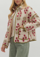 Load image into Gallery viewer, Woman wearing a floral patterned jacket on a plain background
