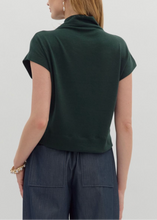 Load image into Gallery viewer, Person wearing a green top and dark pants on a light gray background
