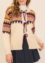 Load image into Gallery viewer, Woman wearing a patterned sweater with a plain background
