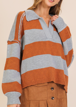 Load image into Gallery viewer, Woman wearing a striped sweater with a neutral background
