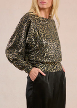 Load image into Gallery viewer, Person wearing a leopard print top and black pants on a beige background
