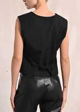 Load image into Gallery viewer, Person wearing a black sleeveless top and black pants against a beige background
