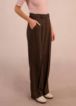 Load image into Gallery viewer, Person wearing brown striped pants on a plain background
