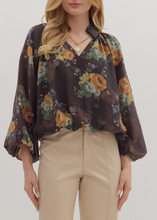 Load image into Gallery viewer, Woman wearing a floral blouse and beige pants on a white background
