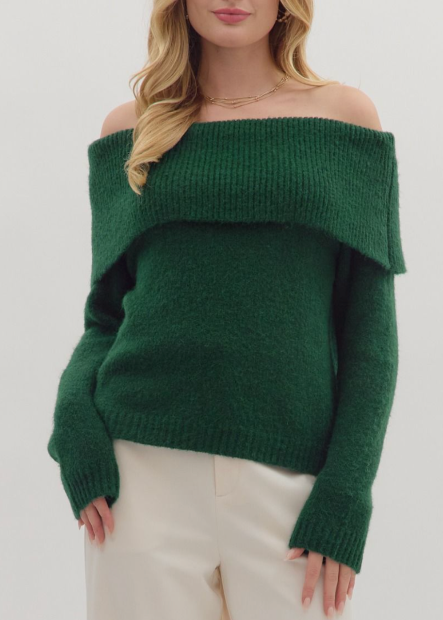 Woman wearing a green off-shoulder sweater against a white background
