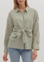 Load image into Gallery viewer, Woman wearing a striped shirt with a tie waist and jeans on a white background
