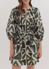 Load image into Gallery viewer, Woman wearing a green and white patterned dress on a white background
