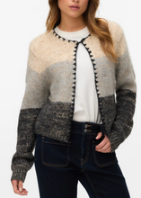 Load image into Gallery viewer, Woman wearing a patterned cardigan with a plain background
