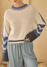 Load image into Gallery viewer, relaxed contrast kit sweater with subtle contrast details with a tan background 
