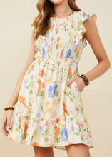 Load image into Gallery viewer, Woman wearing a floral dress with a beige background
