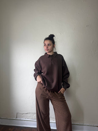 Dark brown OLIVACEOUS Harbor Rugby Sweatshirt LTOP featuring a casual fit and classic rugby style, shown on a hanger.