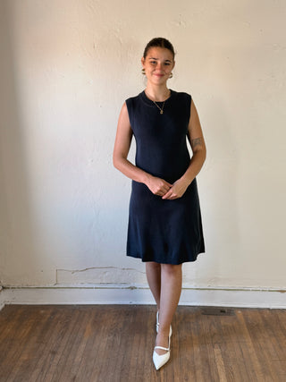 She + Sky Modern Muse sleeveless sweater dress in black, featuring a fitted design and ribbed knit fabric.